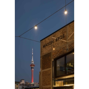 Wynyard Quarter in Auckland at dusk with festoon lighting and the Sky Tower