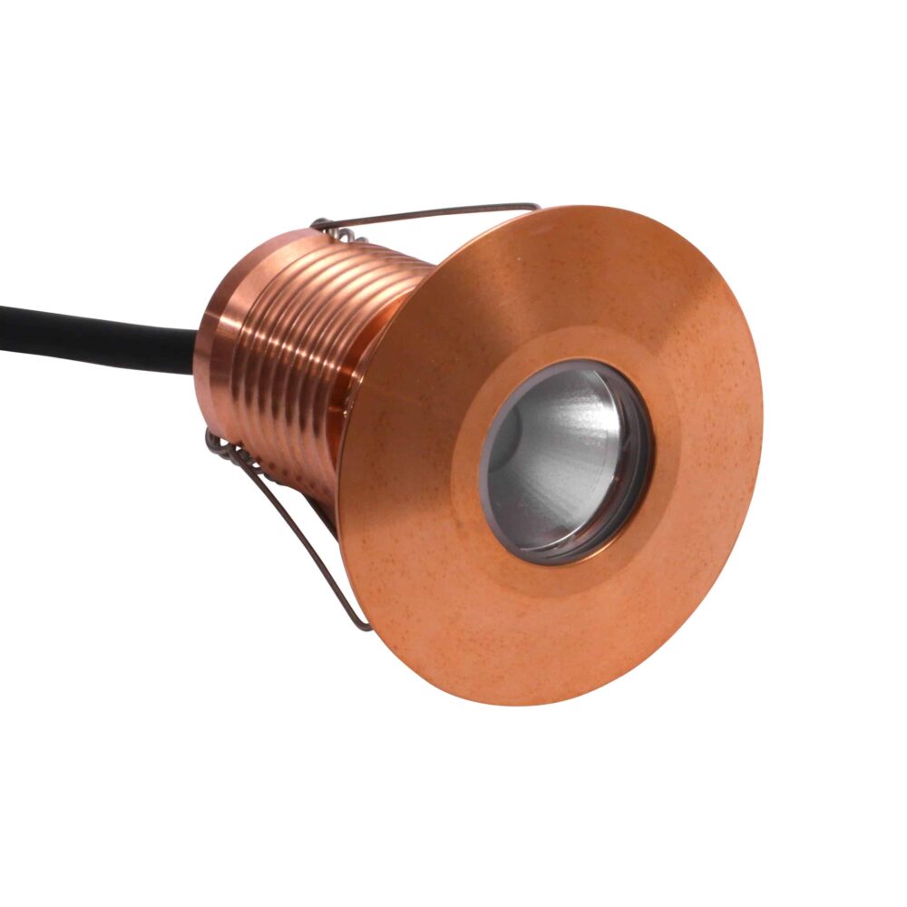 LuxR Modux Four Large Round Recessed Plug in copper with its spring clips