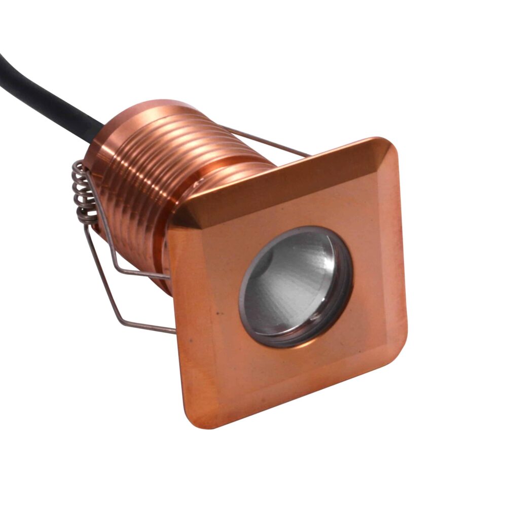 LuxR Modux Four Large Square Recessed Plug in copper with its spring clips